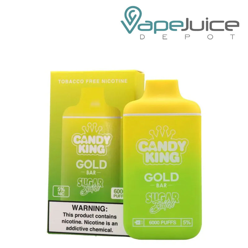 A box of Sugar Batch Candy King Gold Bar 6000 Disposable  with a warning sign and a disposable next to it - Vape Juice Depot