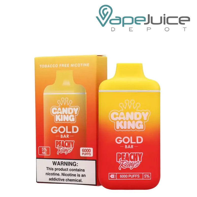 A box of Peach Rings Candy King Gold Bar Disposable  with a warning sign and a disposable next to it - Vape Juice Depot